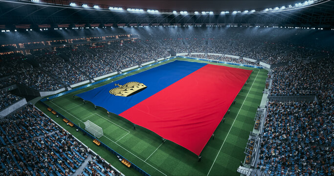 Professional Stadium Soccer Game Championship With Flag of Liechtenstein Spread Across the Pitch Before Football Match Start. Cheering Crowds of Fans Surround the Field. Aerial Wide Shot