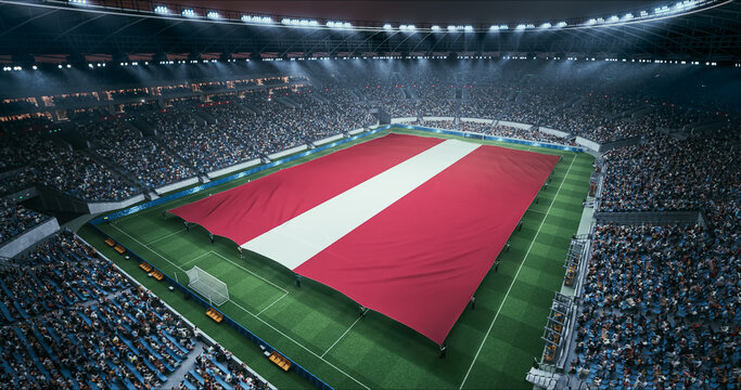 Professional Stadium Soccer Game Championship With Flag of Latvia Spread Across the Pitch Before Football Match Start. Cheering Crowds of Fans Surround the Field. Aerial Wide Shot