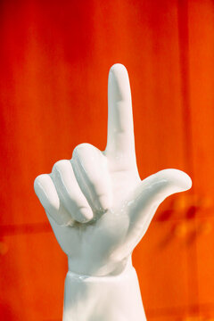 White Pointing Hand on Orange Background