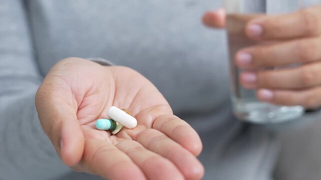 close up woman hand holding a medicine. Stop drug use Taking Medication Caring for the health care medical concept.