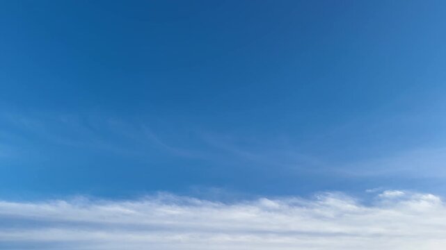 Blue sky with soft wispy cloud band and wide copy space, clean natural background