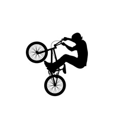 Naklejka premium Silhouette of a BMX rider performing a wheelie trick on a bicycle.