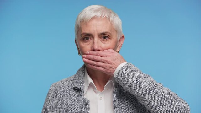 Senior woman making no speak gesture