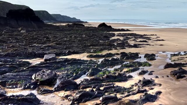 Soft golden sands and rocks on a Cornish beach
