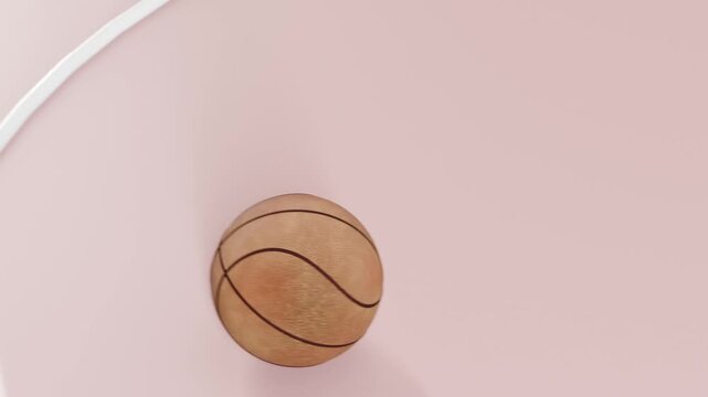 Lens lift revealing wood ball dropping onto pink mat in studio, settling center near white rail