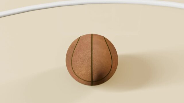 Framing low-angle textured basketball descending through rim at gym court, scoring basket