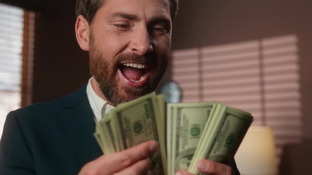 Close up joyful Caucasian mature business man counting money bet gamble victory smile in office middle-aged businessman male trader count cash dollars finance investing trading selling smiling betting