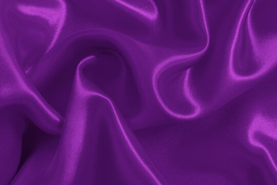 Dark purple fabric texture background, detail of silk or linen pattern.