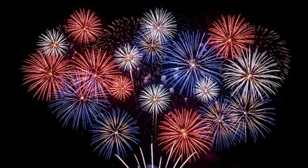 Fototapeta premium Vibrant red white and blue fireworks exploding in night sky on 4th of July American celebration