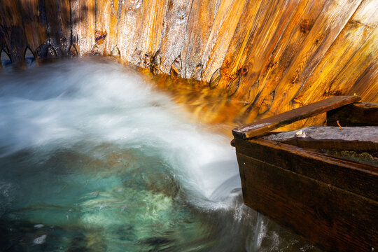 Traditional wooden fulling mill with flowing water and basin