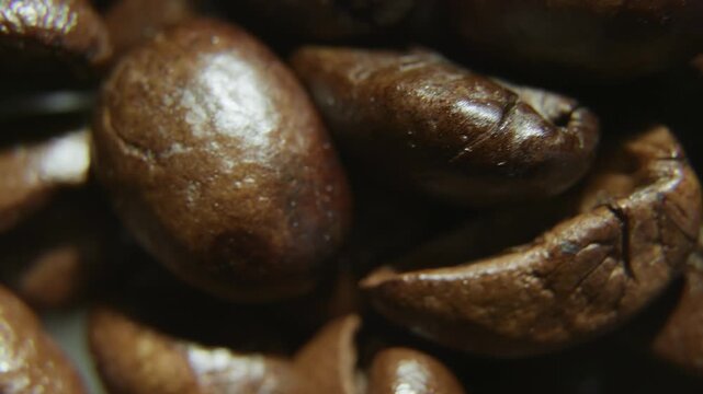 Macro Shot of Roasted Coffee Beans on Dark Surface.