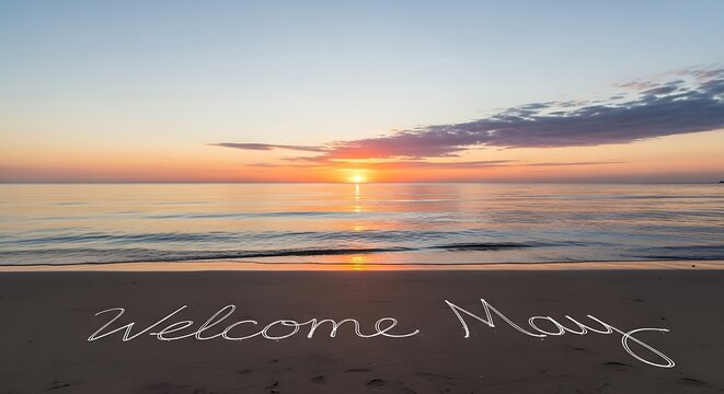 welcome message written in sand at sunrise beach with golden sky and ocean waves
