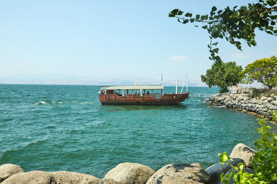 View of the Sea of Galilee with a pleasure boat from the east side on a summer sunny day, July 2019