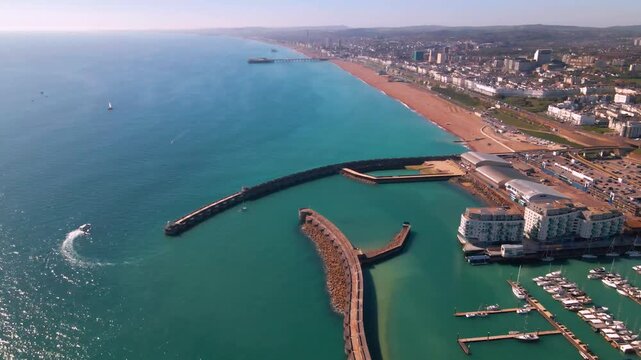 Wide angle drone overview of harbor breakwater and seaside coastline