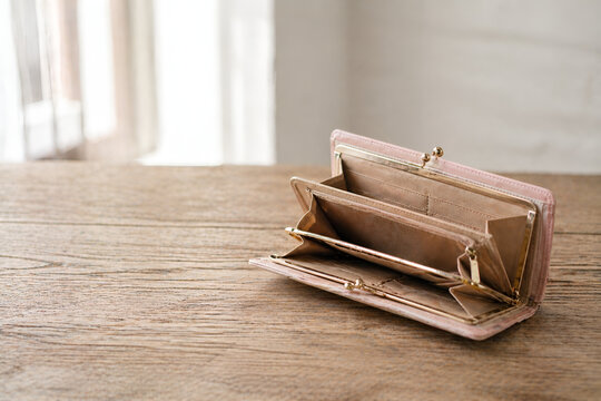 Open empty wallet with no money, financial hardship concept