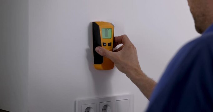 electrician detecting electrical wiring with wall scanner