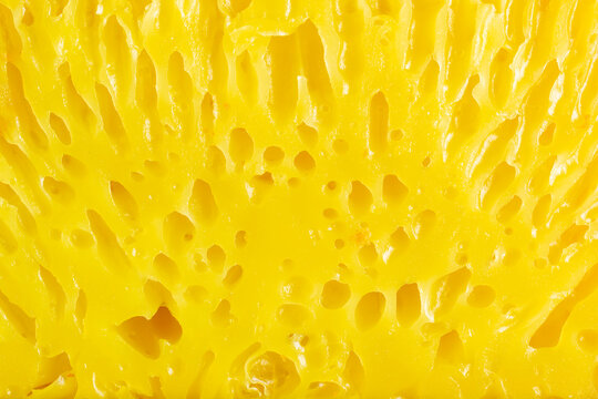 Macro shot of Bika Ambon texture, a traditional Indonesian honeycomb cake made from tapioca flour, eggs, and coconut milk.