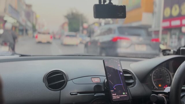POV Driving in Busy Urban Traffic with GPS Navigation on Smartphone, Car Dashboard Interior View, City Street Commute with Vehicles and Motion Blur