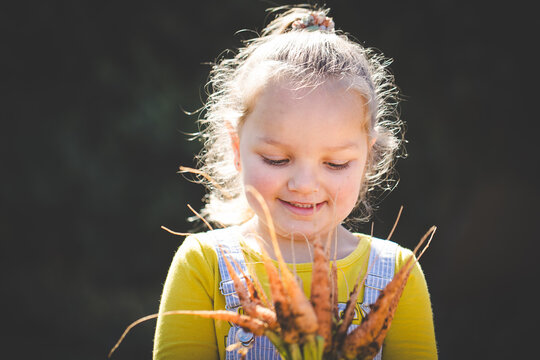 Young child discovering garden plants outdoors