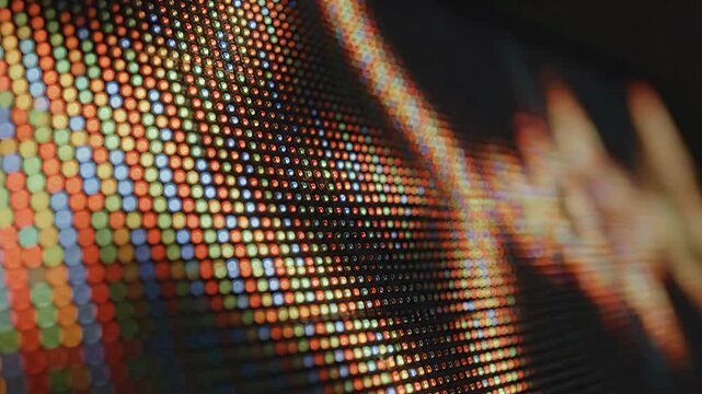 A close-up view reveals a vibrant, pixelated display screen showcasing a colorful array of dots and patterns.