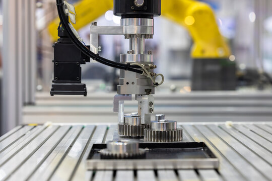 Industrial robotic arm with machine vision camera picking metal gears in automated factory line, Robotic gripper handling steel machine, Automated robotic system smart factory.