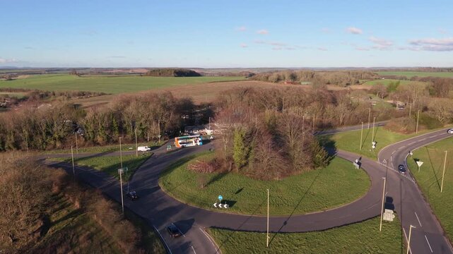 Aerial view of Percy Hobbs roundabout Alresford Road Winchester Hampshire with views across extensive rolling countryside in Southdowns National Park in late afternoon sun with blue sky