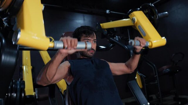 Athlete Training with Shoulder Press Machine During Upper Body Workout. Machine Shoulder Press Exercise in Gym.