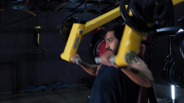 Upper Body Strength Training with Seated Shoulder Press Machine, Man Working Out on a Shoulder Press Machine in Gym.