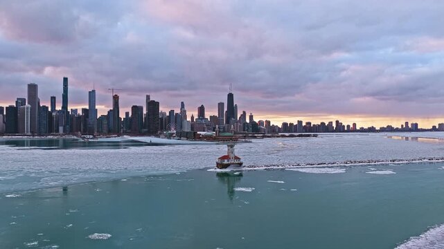 Establishing drone shot of Chicago Harbor Lighthouse and the skyline, winter eve