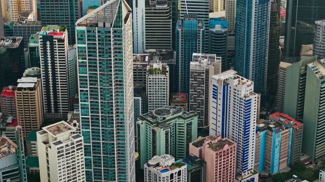 Drone passes dense Makati skyline highlighting urbanization and megacity scale