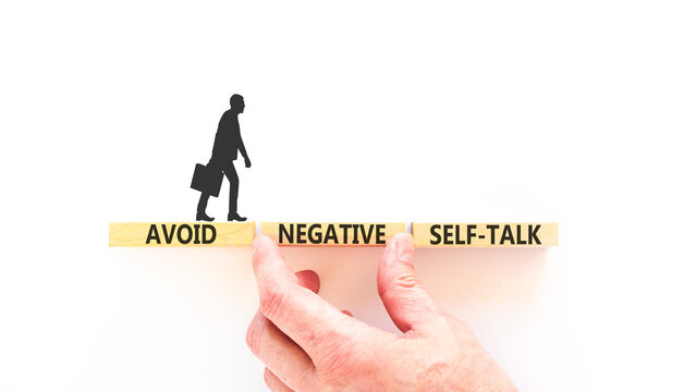 Avoid negative self-talk symbol. Concept words Avoid negative self-talk on beautiful wooden blocks. Beautiful white background. Business psychology avoid negative self-talk concept. Copy space.