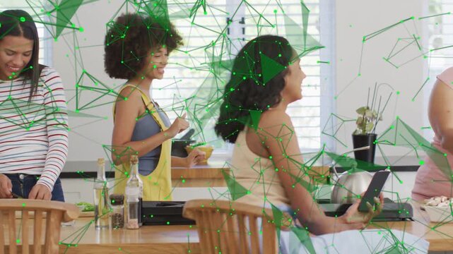 3 women cooking at island, tablet guiding recipe, pink joining, green web animating over tablet