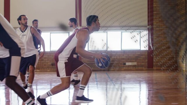 Maroon player gaining basketball under pressure, dribbling, driving and dunking to score in gym