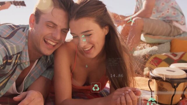 Couple leaning on beach, tapping device coming into view and exploring AR sustainability charts