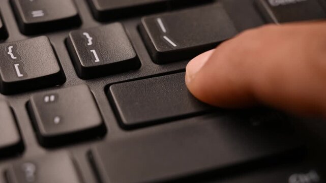 Close Up Keyboard Action of Man Using Enter Key for Data Submission on Computer 