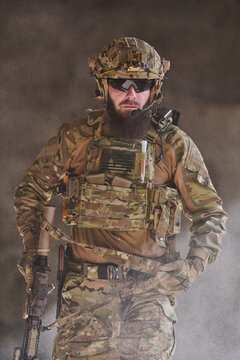 Bearded Special Forces Soldier In Tactical Camouflage Gear With Rifle, Helmet And Plate Carrier