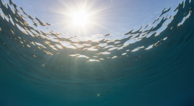 Sunlight filtering through ocean surface waves underwater
