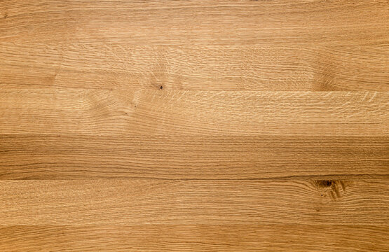 Close up of a wooden surface background, showing warm brown wood grain texture. Perfect for backgrou