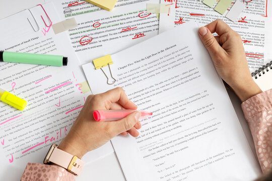 Top view of detailed text correction with visible mistakes and edits, proofreading and quality control of written content using markers and notes. Editer working process