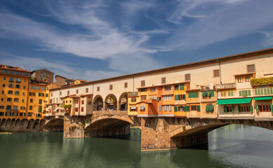 Naklejka premium Ponte Vecchio in Florence, originally built in 1345, is famous for the characteristic shops built above the structure