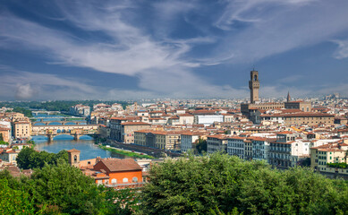 Naklejka premium Florence, The Arno River, the famous Ponte Vecchio and the tower of Palazzo Vecchio are clearly visible.