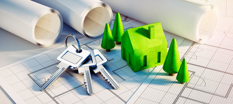 Keychain and keys with green symbol house, trees and architectural plans - concept of planning a home	