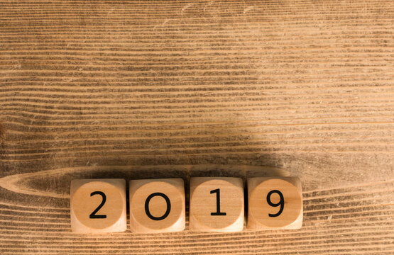 2019 written with wooden blocks on a wooden surface background, perfect for new year concepts and ce