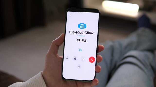 Instant medical consultation. Professional footage of a patient calling CityMed Clinic via smartphone app. Perfect for telehealth, private healthcare, and medical service marketing. Boost your sales