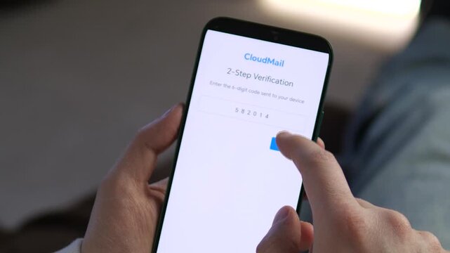 User enters a 2-step verification code on a smartphone to access CloudMail. High-quality footage for cybersecurity, data privacy, and mobile banking ads. Perfect for showcasing modern digital security