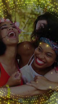Vertical video: 4 friends hugging, woman laughing sparking hug for ad, gold glow pulsing over group