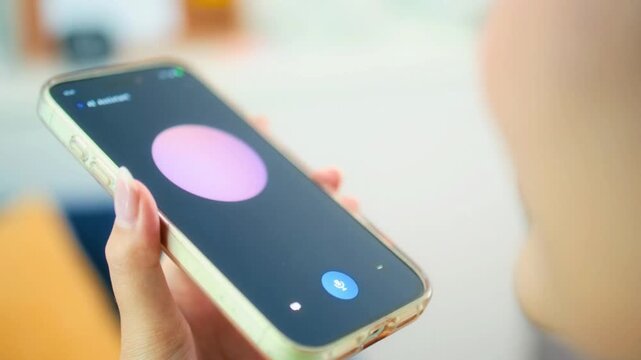 Hand Holding Smartphone with AI Voice Assistant App and Glowing Interface