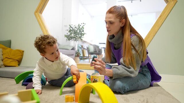 Daycare teacher playing with a little boy