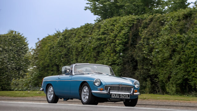 Bicester,Oxon.,UK - Apr 26th 2026:  1972 blue MGB classic British sports car driving on a British road