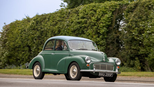 Bicester,Oxon.,UK - Apr 26th 2026: 1968 green Morris Minor car driving on a British road